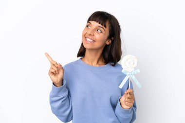 Young mixed race woman holding a lollipop isolated on white background pointing up a great idea