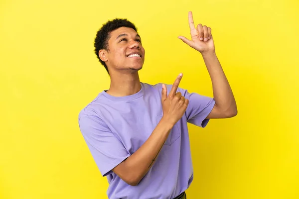 Young African American Man Isolated Yellow Background Pointing Index Finger — Stock Photo, Image