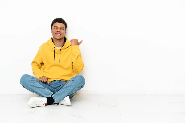 Young African American Man Sitting Floor Isolated White Background Pointing — Stock Fotó