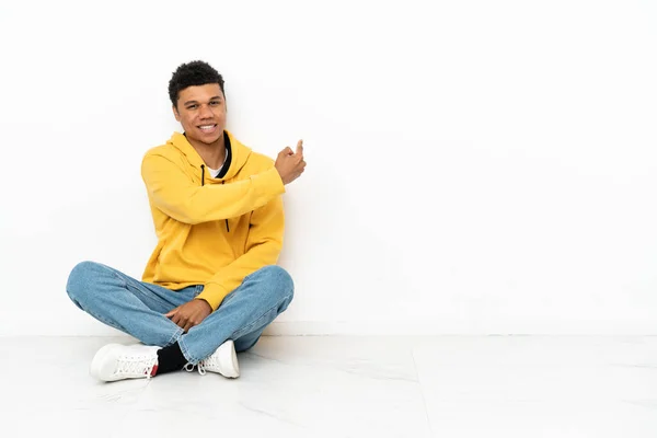 Young African American Man Sitting Floor Isolated White Background Pointing — Foto Stock