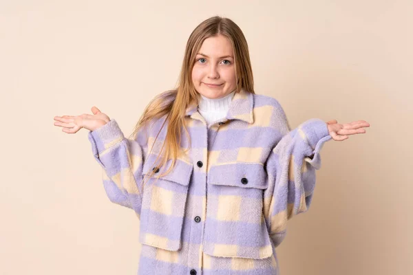 Teenager Ukrainian Girl Isolated Beige Background Making Doubts Gesture — Zdjęcie stockowe