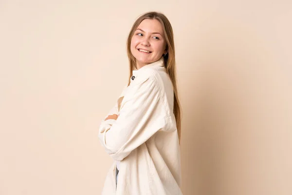 Teenager Ukrainian Girl Isolated Beige Background Looking Side Smiling — Zdjęcie stockowe
