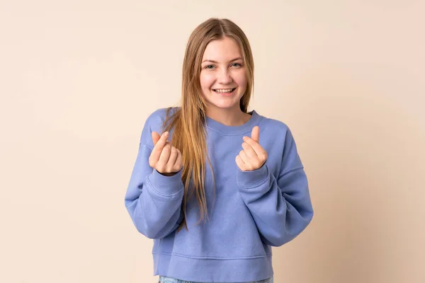 Teenager Ukrainian Girl Isolated Beige Background Making Money Gesture — Stockfoto