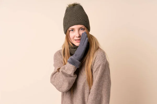 Teenager Ukrainian Girl Winter Hat Isolated Beige Background Whispering Something — Stockfoto