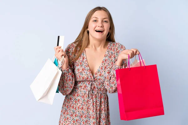Teenager Ukrainian Girl Isolated Blue Background Holding Shopping Bags Surprised — Foto Stock