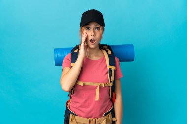 Genç Rus yürüyüşçü kız mavi arka planda mahsur kalmış, şaşırmış ve şok olmuş bir yüz ifadesi var.