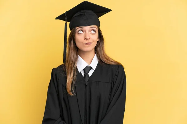 Jonge Afgestudeerde Universiteit Geïsoleerd Gele Achtergrond Zoek Omhoog — Stockfoto