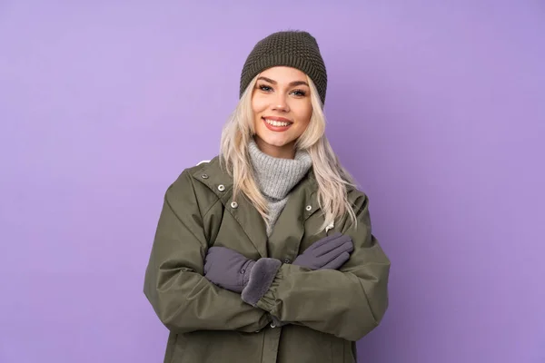 Teenager Blonde Girl Winter Hat Isolated Purple Background Keeping Arms — стоковое фото