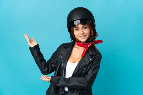 Teenager Biker Girl Isolated Blue Background Extending Hands Side Inviting — стоковое фото