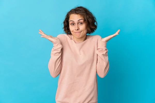 Young English Woman Isolated Blue Background Having Doubts While Raising — Fotografia de Stock