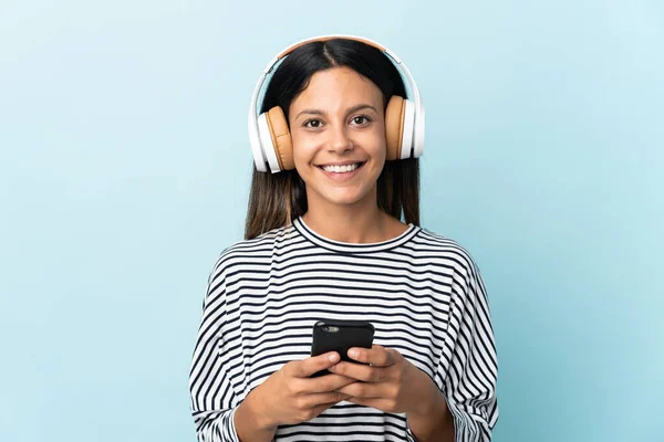 Caucásico Chica Aislado Azul Fondo Escuchar Música Con Móvil Mirando — Foto de Stock