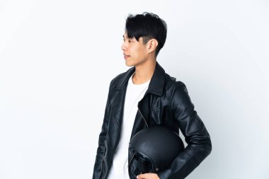 Chinese man with a motorcycle helmet isolated on white background looking side