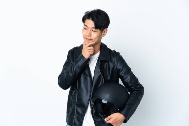 Chinese man with a motorcycle helmet isolated on white background looking to the side and smiling