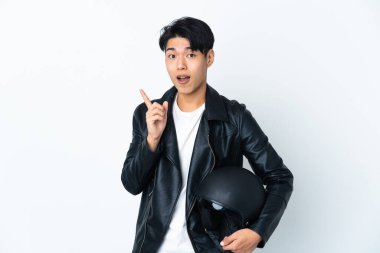 Chinese man with a motorcycle helmet isolated on white background intending to realizes the solution while lifting a finger up