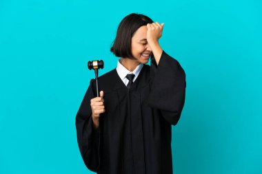 Judge over isolated blue background has realized something and intending the solution