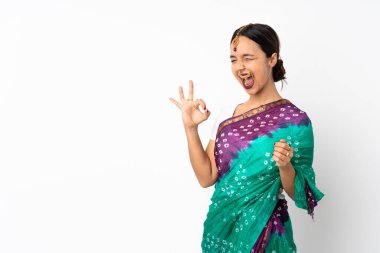 Beyaz arka planda izole edilmiş genç Hintli kadın parmaklarıyla işaret gösteriyor.