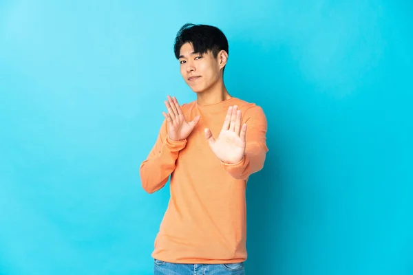 Young Chinese Man Isolated Blue Background Nervous Stretching Hands Front —  Fotos de Stock