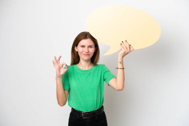 Beyaz arka planda izole edilmiş genç bir İngiliz kadın boş bir konuşma balonu tutuyor ve 