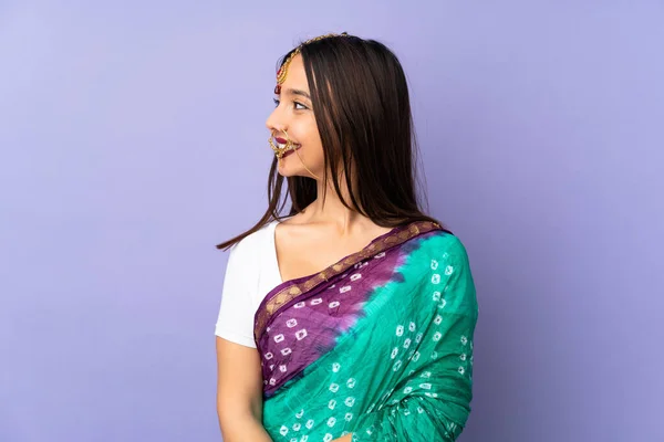 Young Indian Woman Isolated Purple Background Looking Side — стокове фото