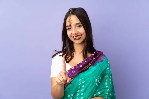 Young Indian Woman Isolated Purple Background Showing Lifting Finger — стоковое фото