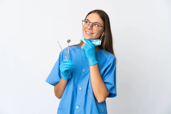 Lithuanian Woman Dentist Holding Tools Isolated Background Looking While Smiling — Zdjęcie stockowe