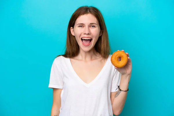 Young English Woman Holding Donut Isolated Blue Background Surprise Shocked — Stockfoto