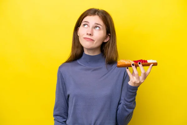 Young English Woman Holding Sashimi Isolated Yellow Background Looking — Stock Fotó