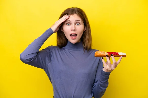 Young English Woman Holding Sashimi Isolated Yellow Background Surprise Expression — стоковое фото