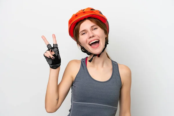 Young Cyclist English Woman Isolated White Background Smiling Showing Victory — стоковое фото