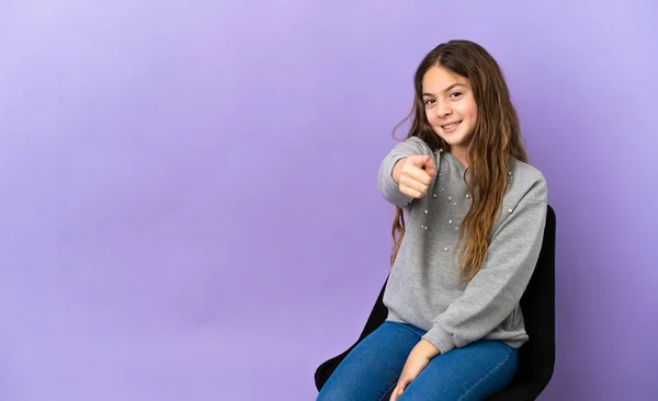 Little Caucasian Girl Sitting Chair Isolated Purple Background Pointing Front — Stock fotografie