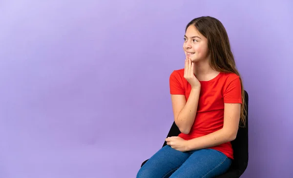 Little Caucasian Girl Sitting Chair Isolated Purple Background Looking While — 스톡 사진
