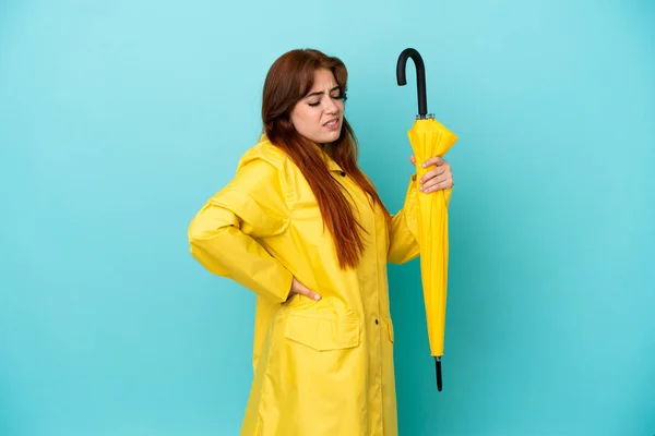Redhead Woman Holding Umbrella Isolated Blue Background Suffering Backache Having — Stockfoto