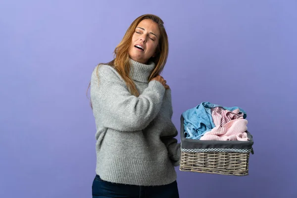 Middle Age Woman Holding Clothes Basket Isolated Purple Background Suffering — Stockfoto