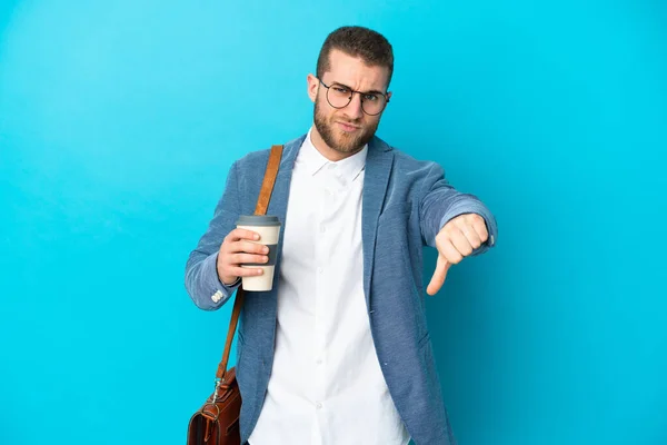 Young Caucasian Businessman Isolated Blue Background Showing Thumb Negative Expression — Fotografie, imagine de stoc