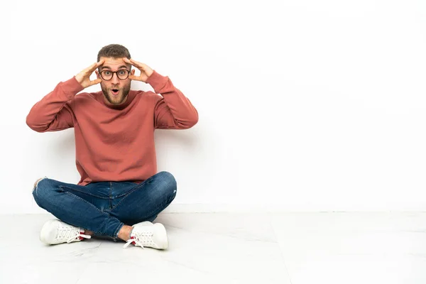 Young Handsome Man Sitting Floor Surprise Expression — Zdjęcie stockowe