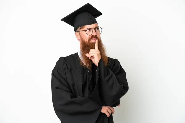 Young University Graduate Reddish Man Isolated White Background Having Doubts — стоковое фото