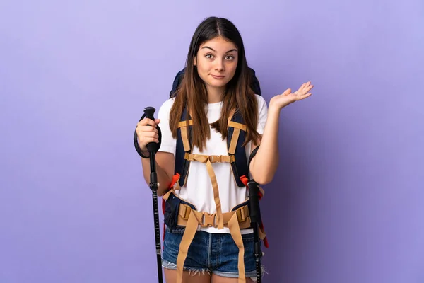 Young Woman Backpack Trekking Poles Isolated Purple Background Having Doubts — Stock Photo, Image