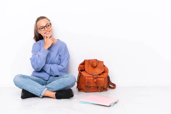 Young Student Girl Sitting One Floor Isolated White Background Looking — Zdjęcie stockowe