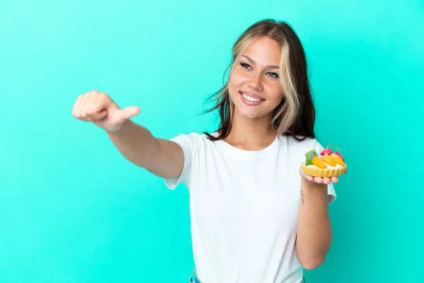 Young Russian Woman Holding Fruit Sweet Isolated Blue Background Giving — Stockfoto