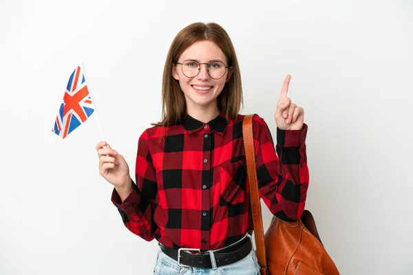 一位年轻女子举着一面英国国旗 背景是蓝色的 这说明了一个伟大的想法 — 图库照片