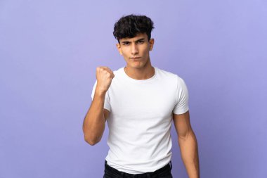 Young Argentinian man isolated on background with unhappy expression