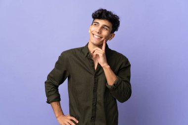 Arjantinli genç adam arka planda izole edilmiş bir şekilde bir fikir ararken...