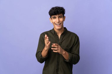 Young Argentinian man isolated on background applauding after presentation in a conference
