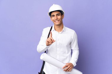 Young architect man isolated on background showing and lifting a finger