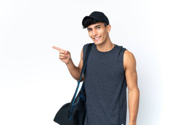 Young sport Argentinian man with sport pointing finger to the side