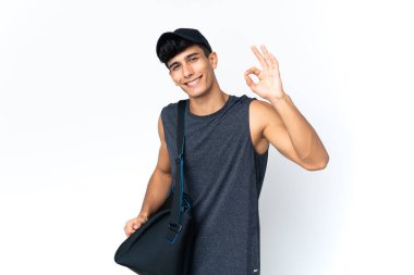 Young sport Argentinian man with sport showing ok sign with fingers
