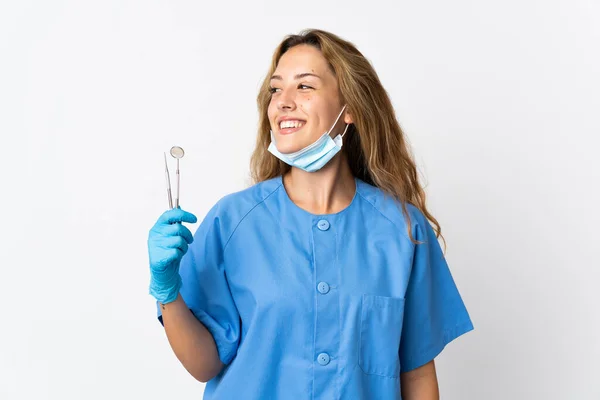 Woman Dentist Holding Tools Isolated White Background Looking Side — Stock fotografie