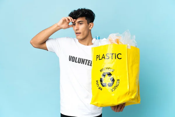 Young Argentinian Man Holding Bag Full Plastic Doing Surprise Gesture — Foto de Stock