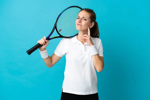 Joven Jugadora Tenis Aislada Sobre Fondo Azul Teniendo Dudas —  Fotos de Stock