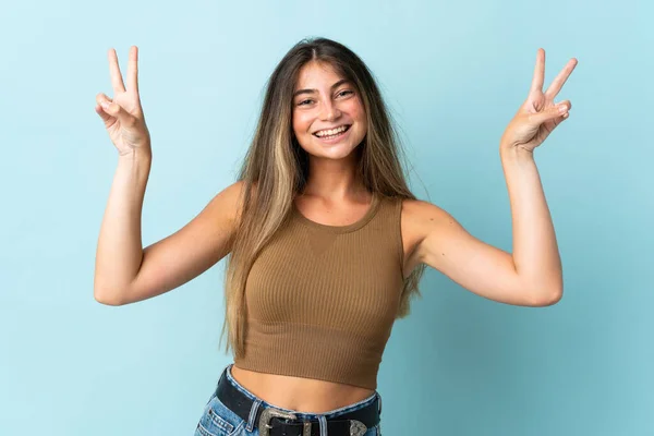 Jonge Kaukasische Vrouw Geïsoleerd Blauwe Achtergrond Tonen Overwinning Teken Met — Stockfoto